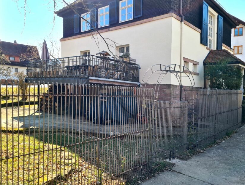 170 cm hoher Zaun neben einem Rosenbogen mit 145 cm hohem Tor.